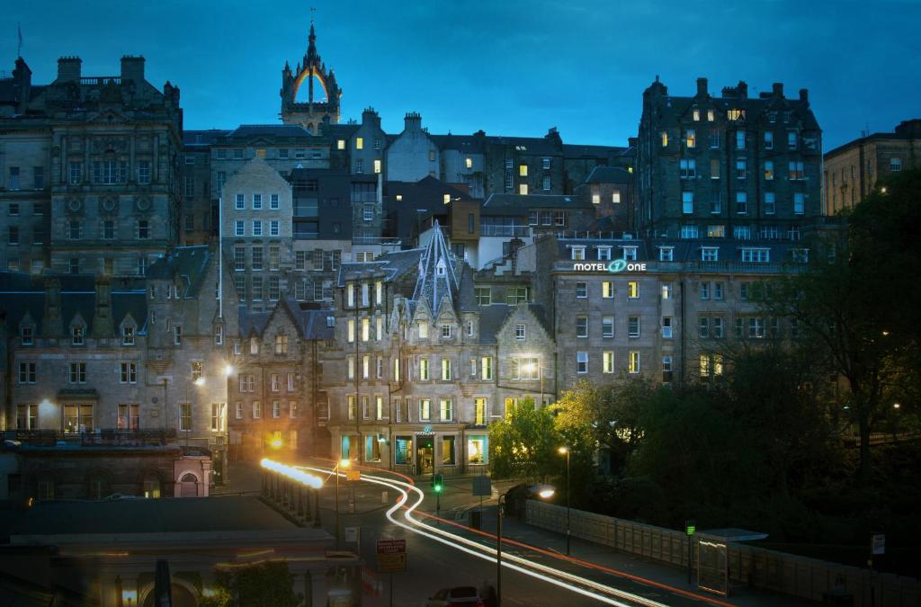 a city street with buildings and a clock tower at Motel One Edinburgh-Royal in Edinburgh
