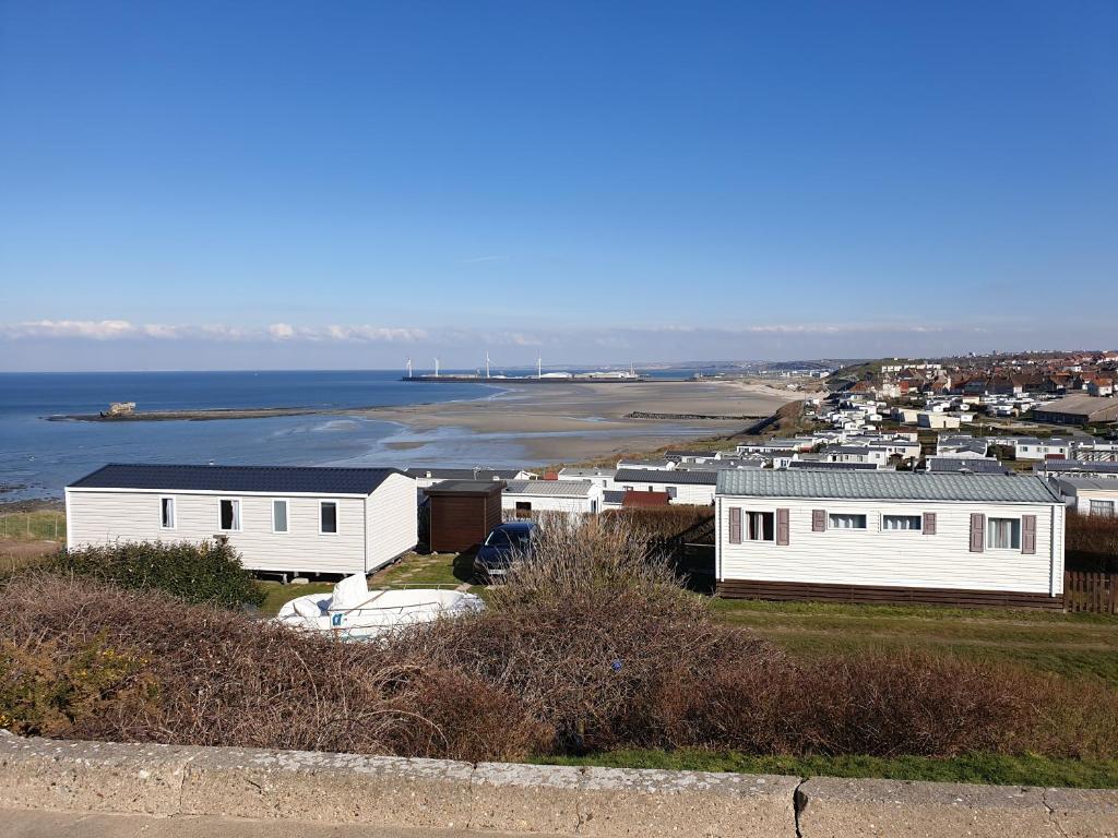 uma vista para uma cidade com casas e o oceano em Le Phare d'Opale I, T04 em Le Portel