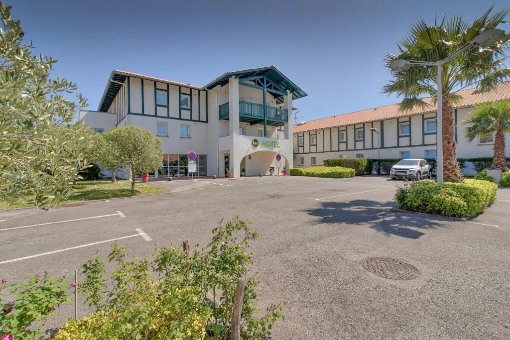 a parking lot in front of a large building at B&B HOTEL Saint Jean de Luz in Saint-Jean-de-Luz