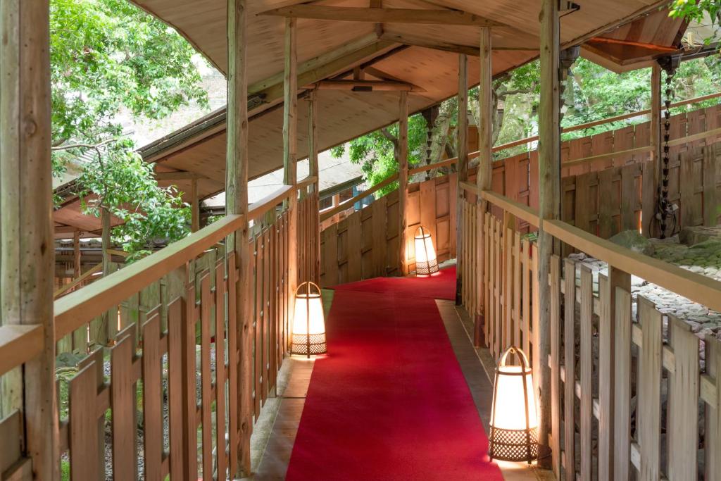 a walkway with lights and a red carpet at Tsukihitei in Nara