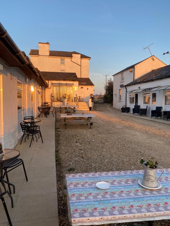 a blanket on the ground in front of a patio at Old Stagecoach stables rooms only in Crewkerne