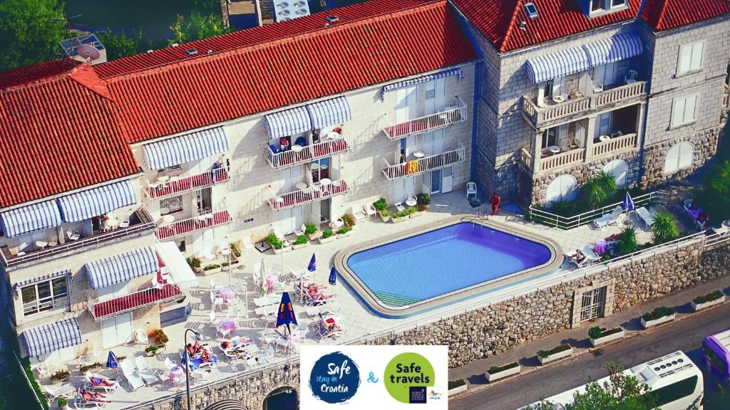an overhead view of a building with a swimming pool at Hotel Komodor in Dubrovnik