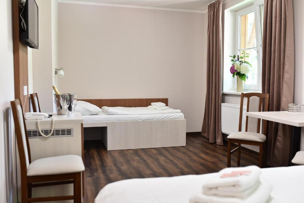 Postel nebo postele na pokoji v ubytování Wellness Hotel Bozeňov