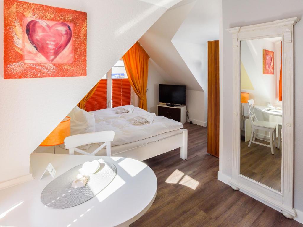 a bedroom with a bed with a heart painting on the wall at Villa Binz - Apt. 04 in Binz