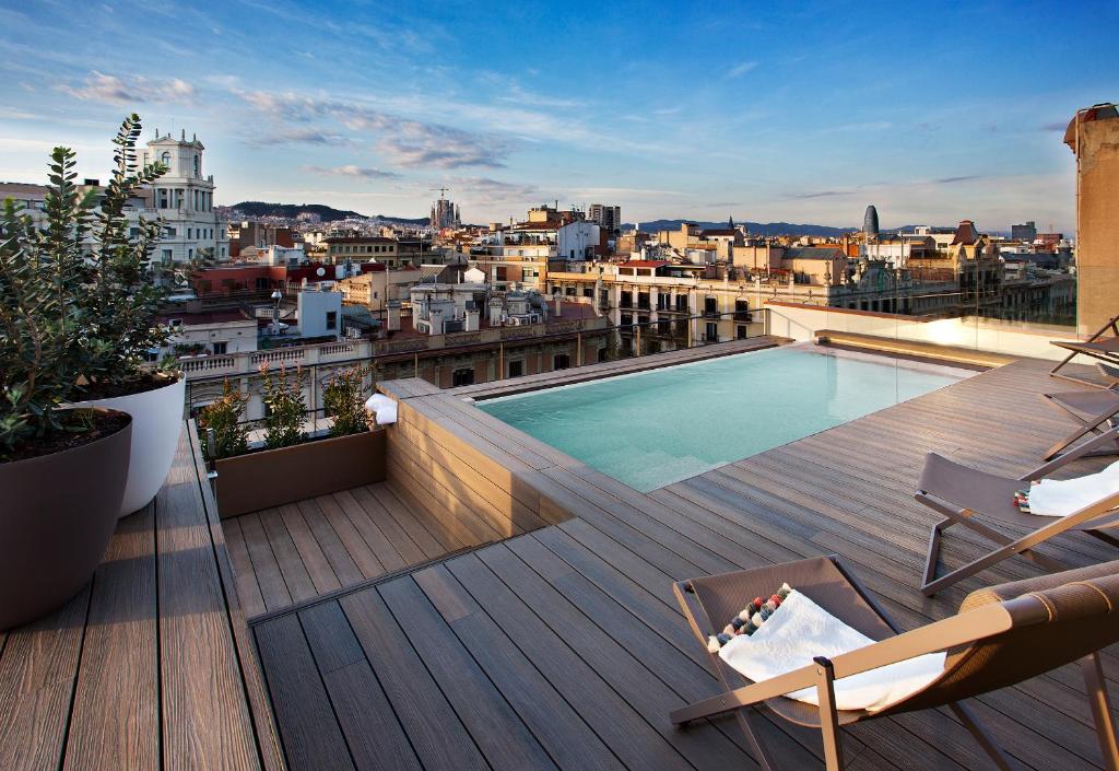 a balcony with a swimming pool on top of a building at Vincci Gala in Barcelona