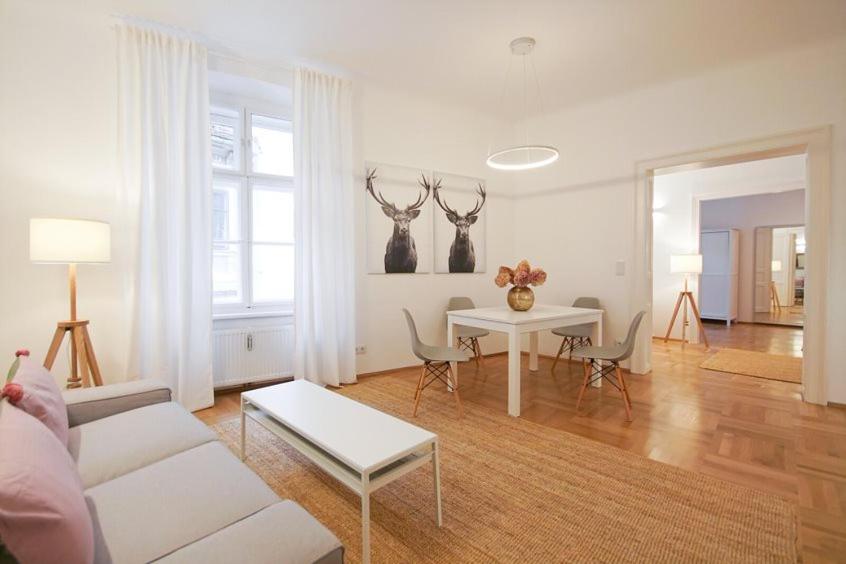 a living room with a white couch and a table at Apartment Congress Graz in Graz