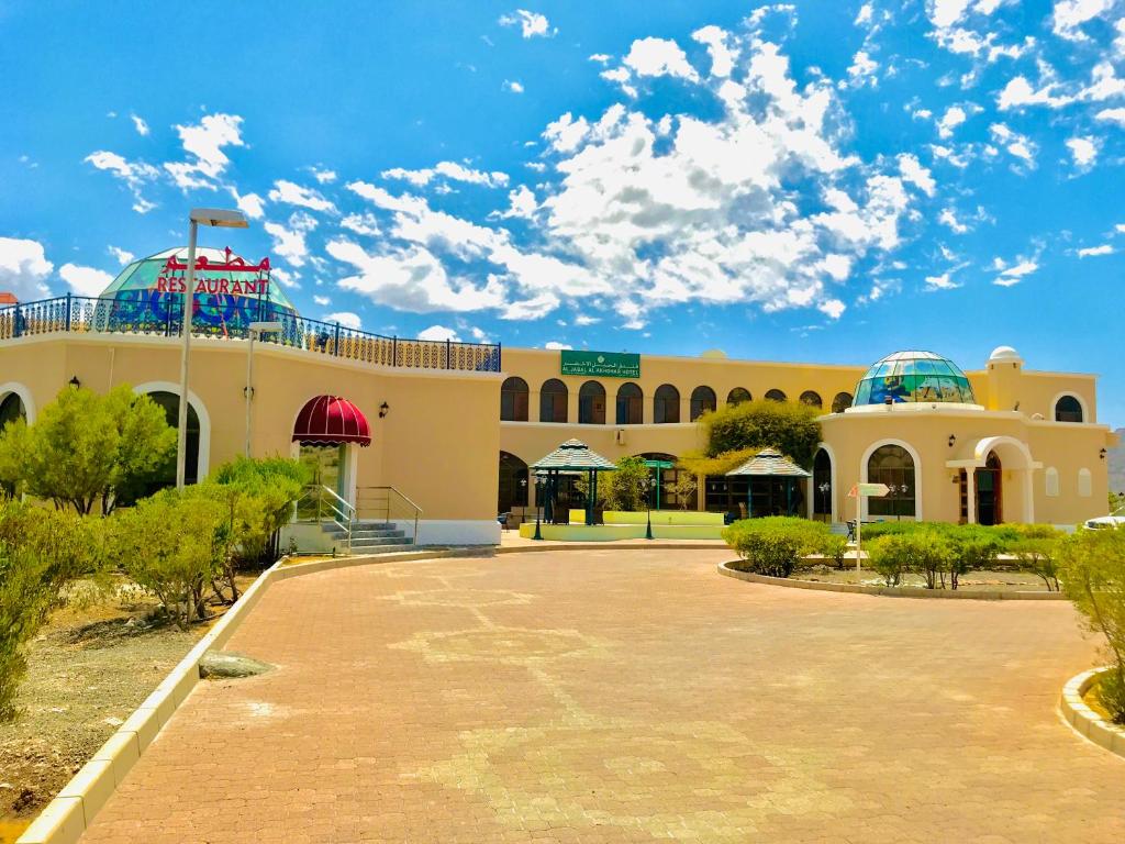 um edifício com um parque de estacionamento em frente em Jabal Akhdhar Hotel em Al ‘Aqar