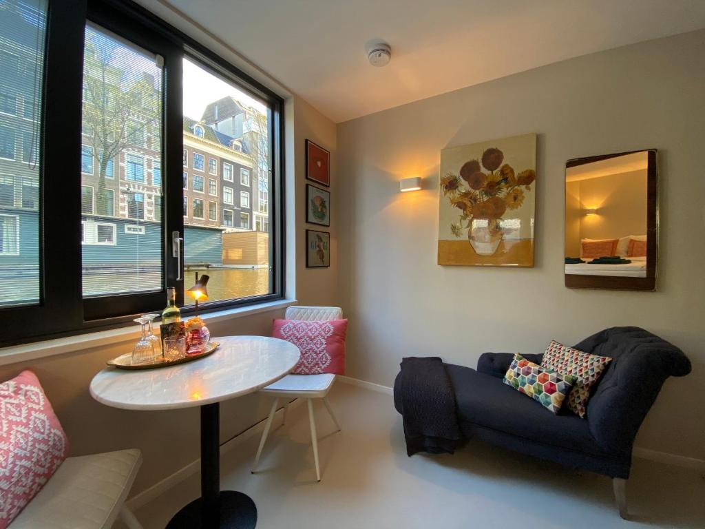 a living room with a table and a couch at Houseboat Sophia in Amsterdam