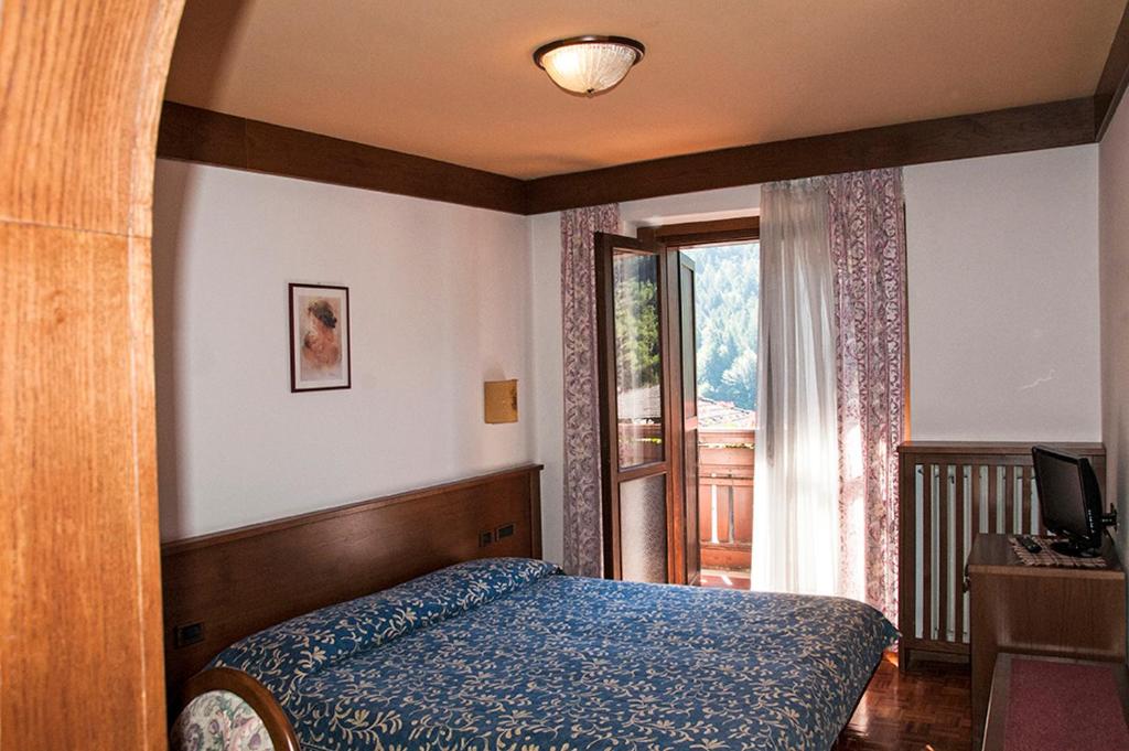 Postel nebo postele na pokoji v ubytování Hotel Carlone
