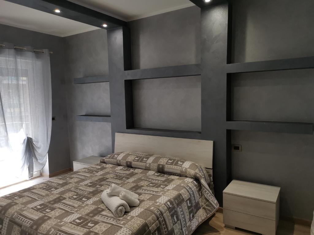 a bedroom with a bed with two pillows on it at CAV Black Pearl by People in Turin