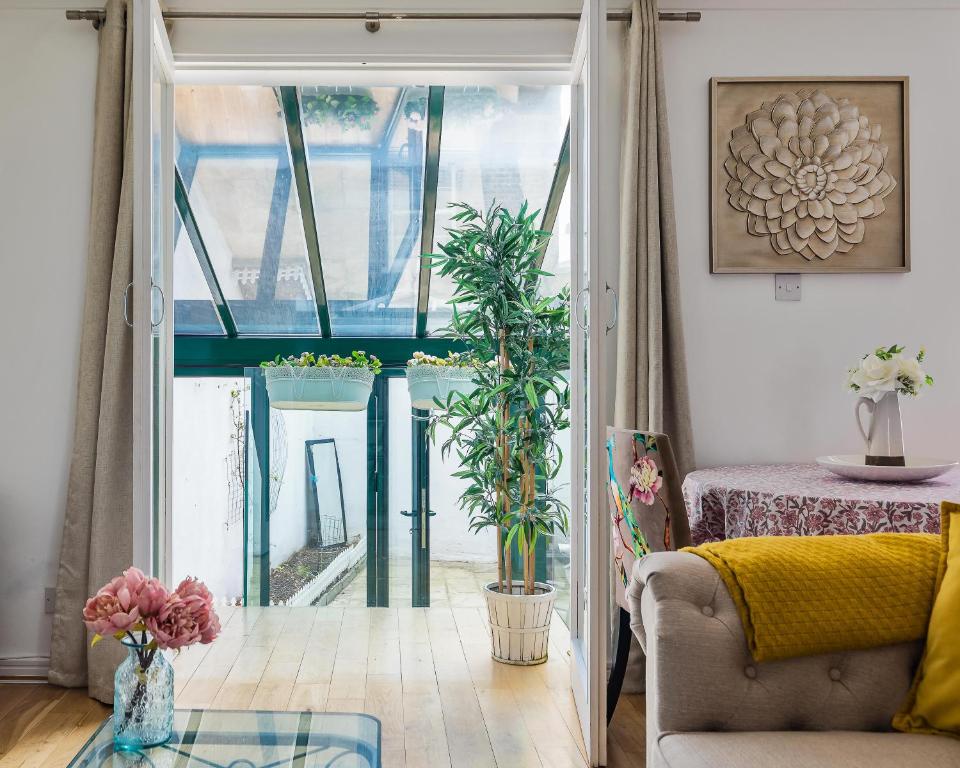 a living room with a door open to a patio at PickThePlace Crawford place suites in London