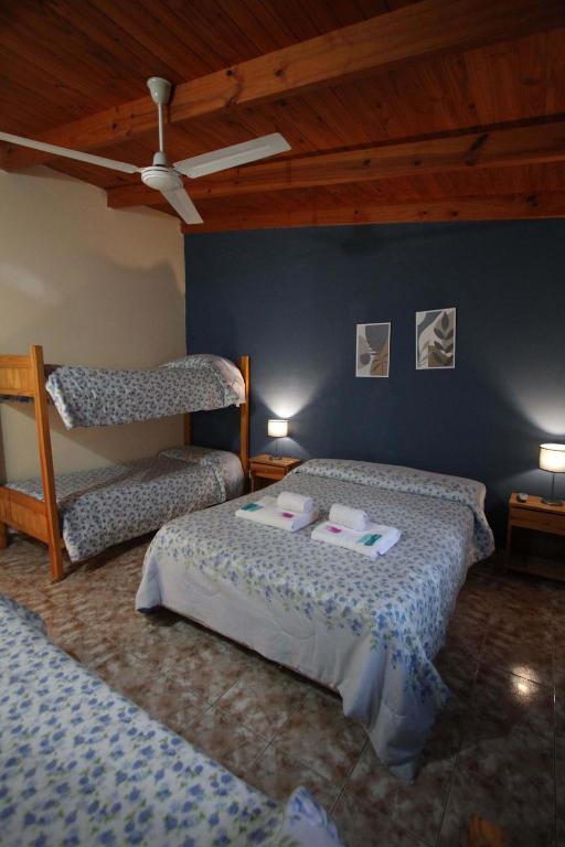 a bedroom with two beds and a bunk bed at Las Cabañas in Colorado River