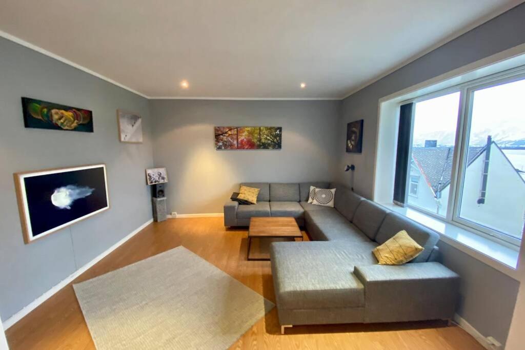 a living room with a couch and a table at Nice and central apartment in quiet area in Ålesund