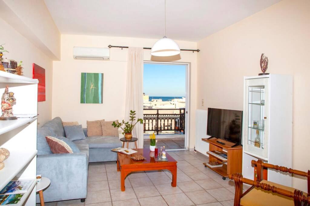 a living room with a couch and a tv at City & beach apartment I in Rethymno in Rethymno