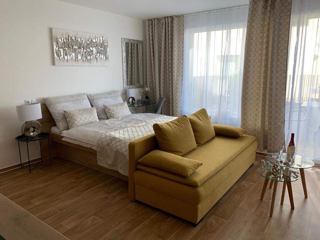 a bedroom with a bed and a couch at Apartmány Speicher in Mikulov