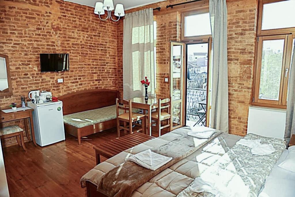 a room with a bed and a table with a kitchen at Santrivani Rooms in Chania Town