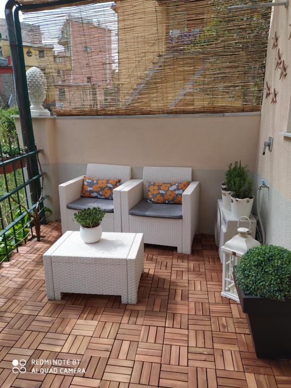 a patio with two chairs and a table at Rio Groppo Guesthouse in Manarola