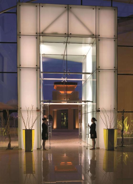 people standing in front of a glass building at Traders Hotel, Abu Dhabi in Abu Dhabi
