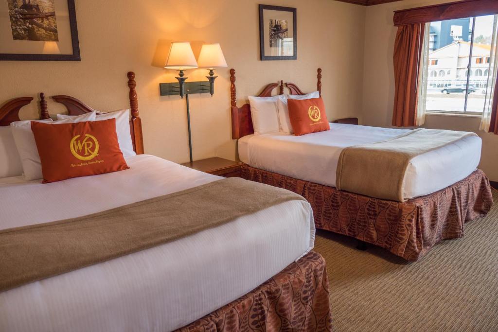 a hotel room with two beds and a window at Wild Bear Inn in Pigeon Forge
