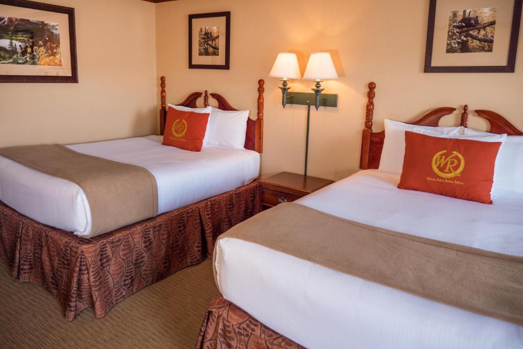 a hotel room with two beds and two lamps at Wild Bear Inn in Pigeon Forge