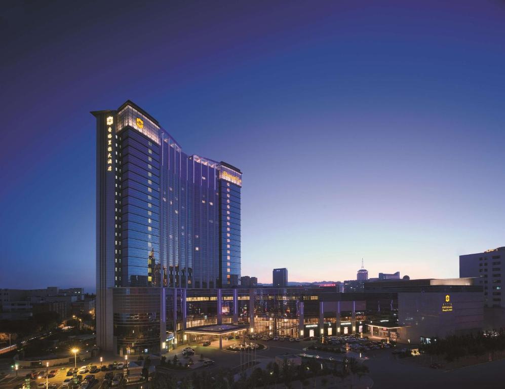 a tall building in a city at night at Shangri-La Huhhot in Hohhot