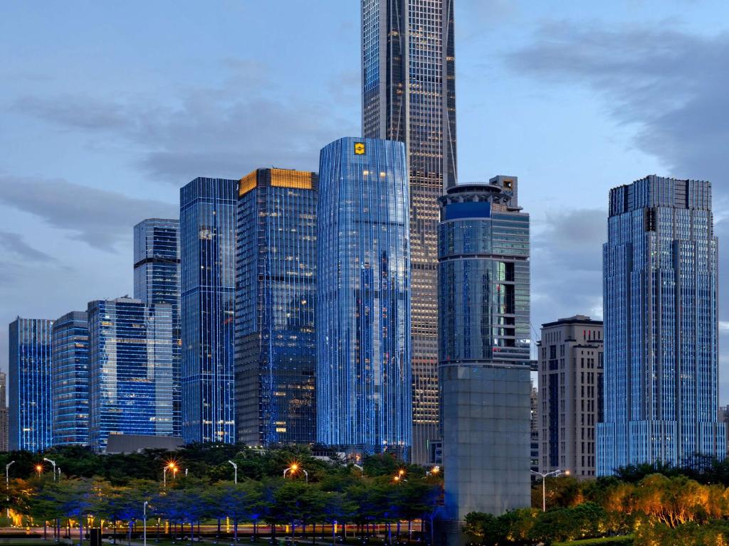 a group of tall buildings in a city at Futian Shangri-La, Shenzhen,Near to Shenzhen Convention&Exhibition Centre, Futian Railway Station in Shenzhen