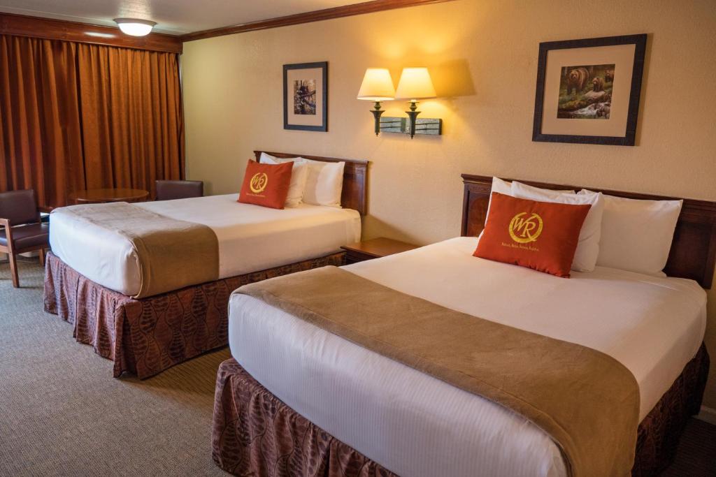 a hotel room with two beds in a room at Wild Bear Inn in Pigeon Forge