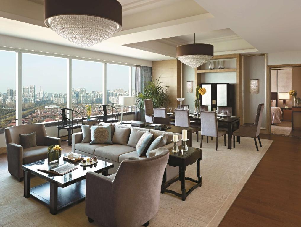 a living room filled with furniture and a large window at Kerry Hotel Pudong, Shanghai in Shanghai