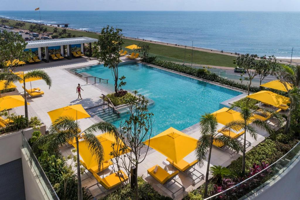 an overhead view of a swimming pool with yellow umbrellas at Shangri-La Colombo in Colombo