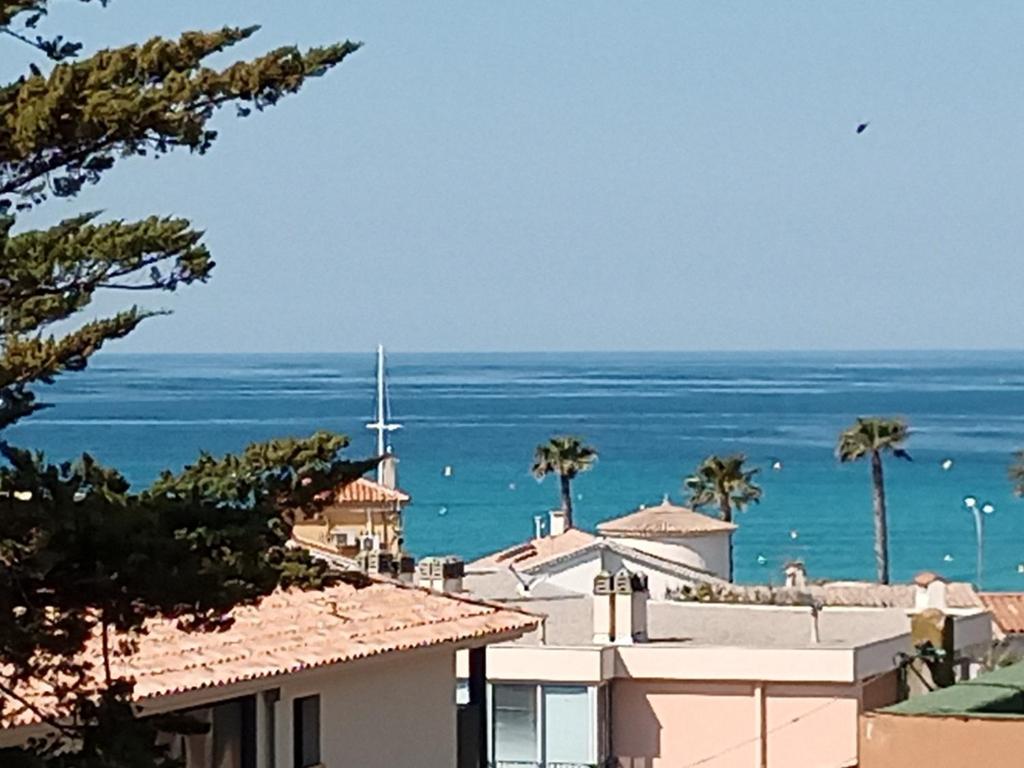 a view of the ocean from a building at T2 Terrasse vue mer in Six-Fours-les-Plages
