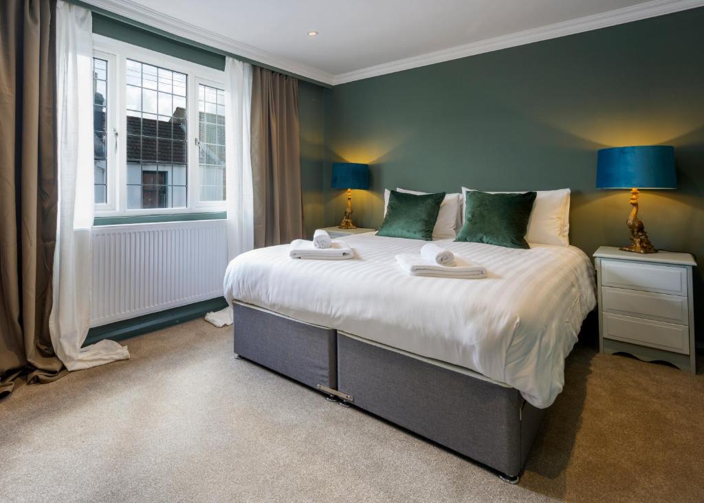 a bedroom with a large bed and a window at Stylish Upper Gardner Street - With Free Parking in Brighton & Hove