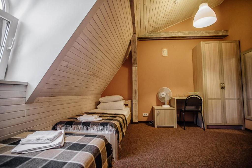 Postel nebo postele na pokoji v ubytování Guest House "Arkhistratyg"
