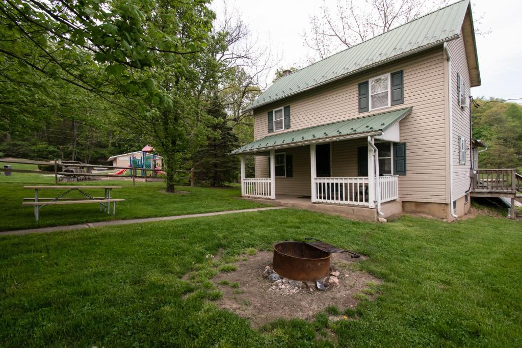 a house with a fire pit in the yard at Spring Gulch Country House 9 in Mount Airy