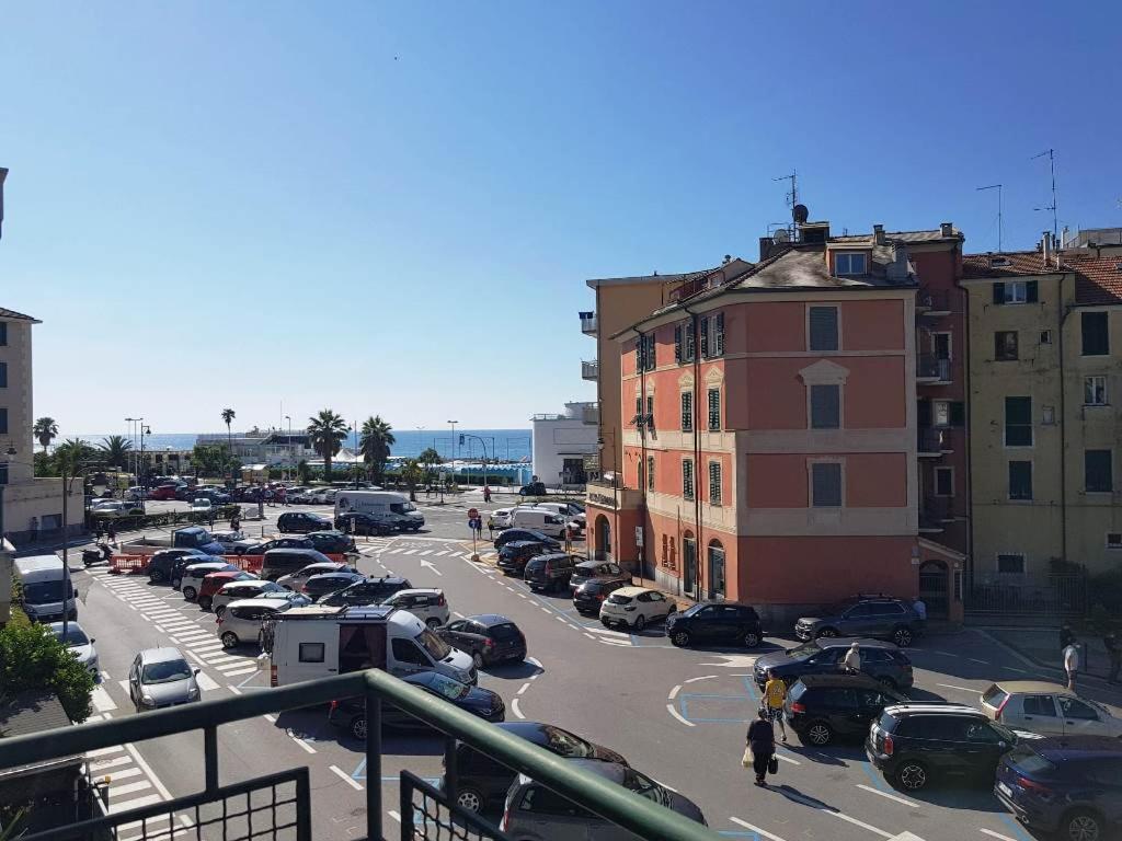 a parking lot with cars parked in a city at Mare & Relax in Albissola Marina