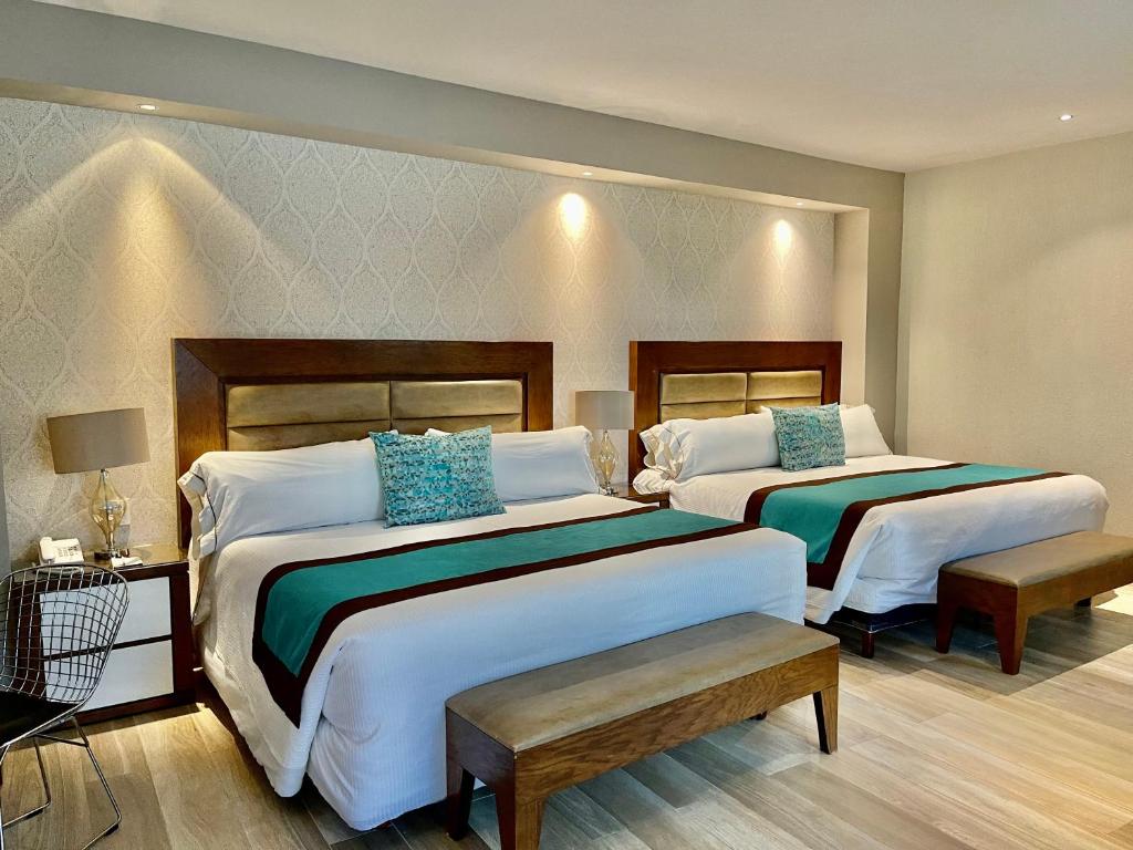 Postel nebo postele na pokoji v ubytování Áurea Hotel and Suites