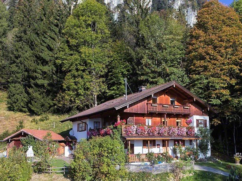 a house with flowers on the side of it at Ferienwohnung Bischofshäusl in Berchtesgaden