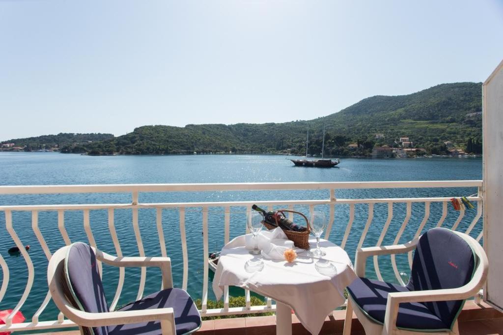 a table with a bottle of wine sitting on a balcony at Villa Malfi in Zaton