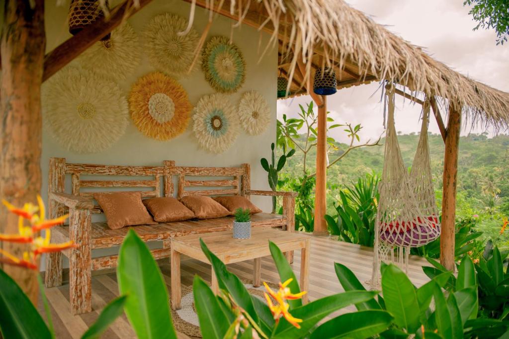a room with a bed and a hammock at kaje cottage & restaurant in Nusa Penida
