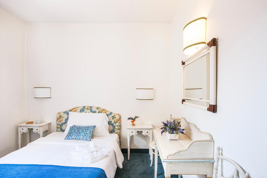 Postel nebo postele na pokoji v ubytování Albergo Al Moretto