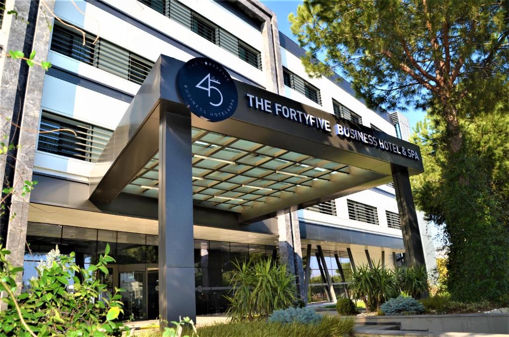 a building with a sign in front of a building at The Fortyfive Business Hotel & Spa in Manisa