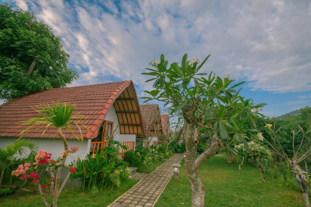 a house with a tile roof and some trees at kaje cottage & restaurant in Nusa Penida