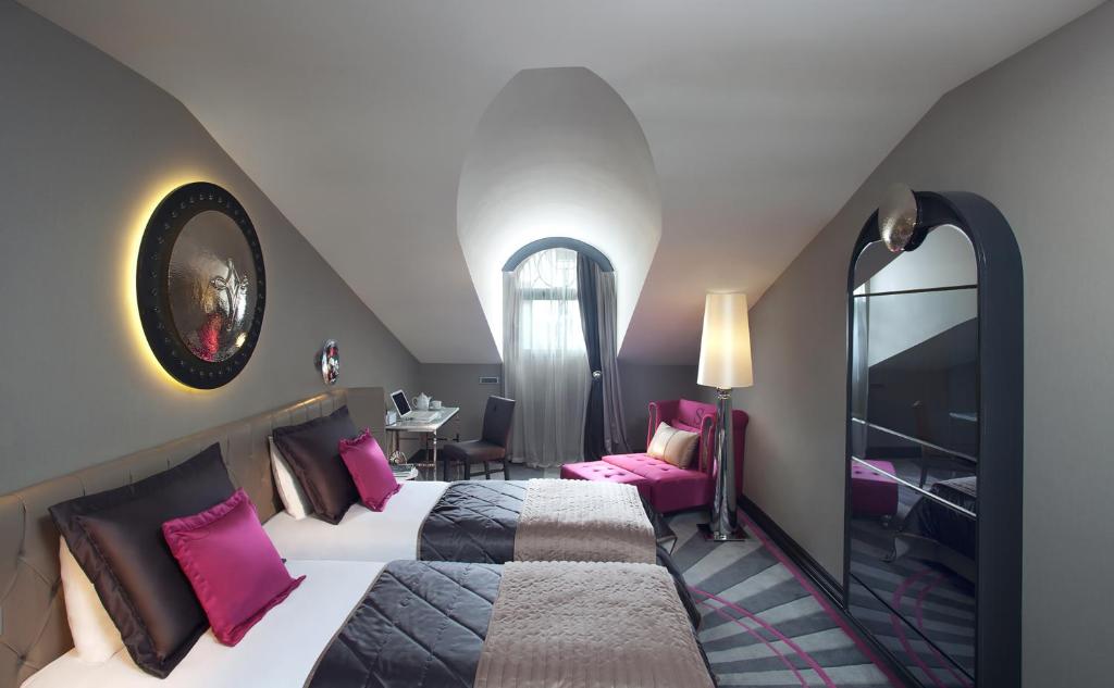 A bed or beds in a room at Sura Design Hotel & Suites