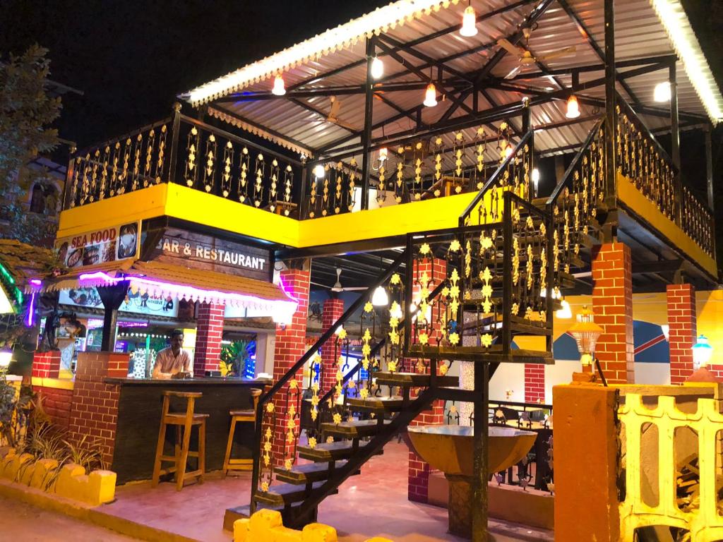 a bar with a staircase leading up to a building at Casa Salvador in Calangute