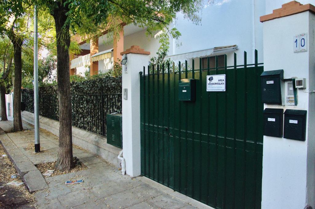 a green gate in front of a house at Casa Lighea Mondello - 200 mt dalla spiaggia in Mondello