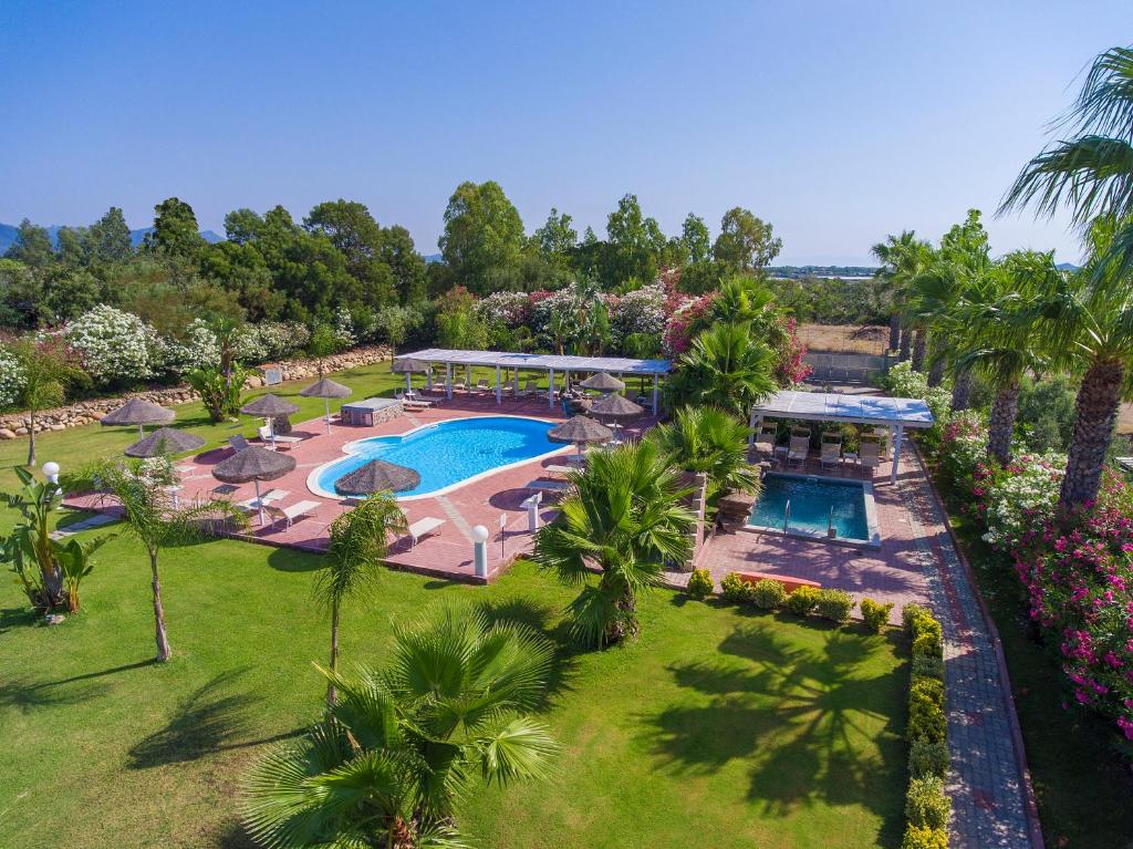 an aerial view of a resort with a swimming pool at Hotel Rurale Orti di Nora & SPA in Santa Margherita di Pula