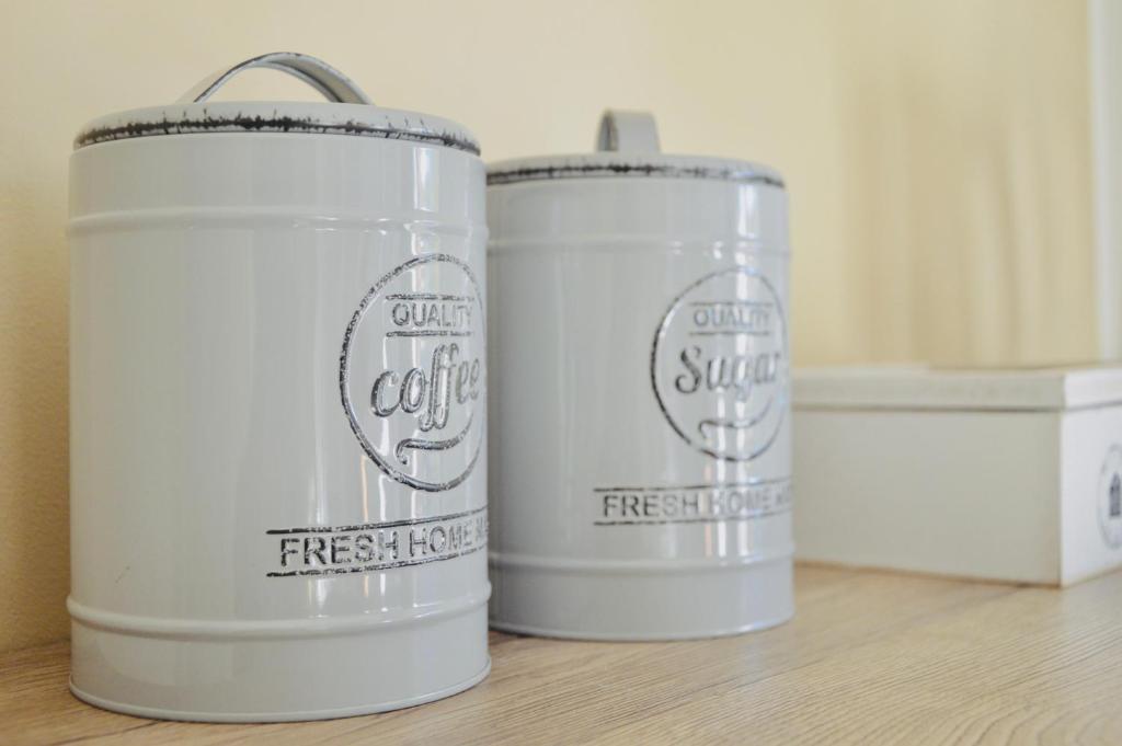 two white canisters sitting on top of a table at Casa Lighea Mondello - 200 mt dalla spiaggia in Mondello