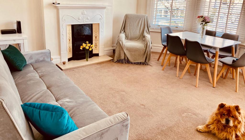 a living room with a couch and a table at Alexandra Beach Haven in Worthing