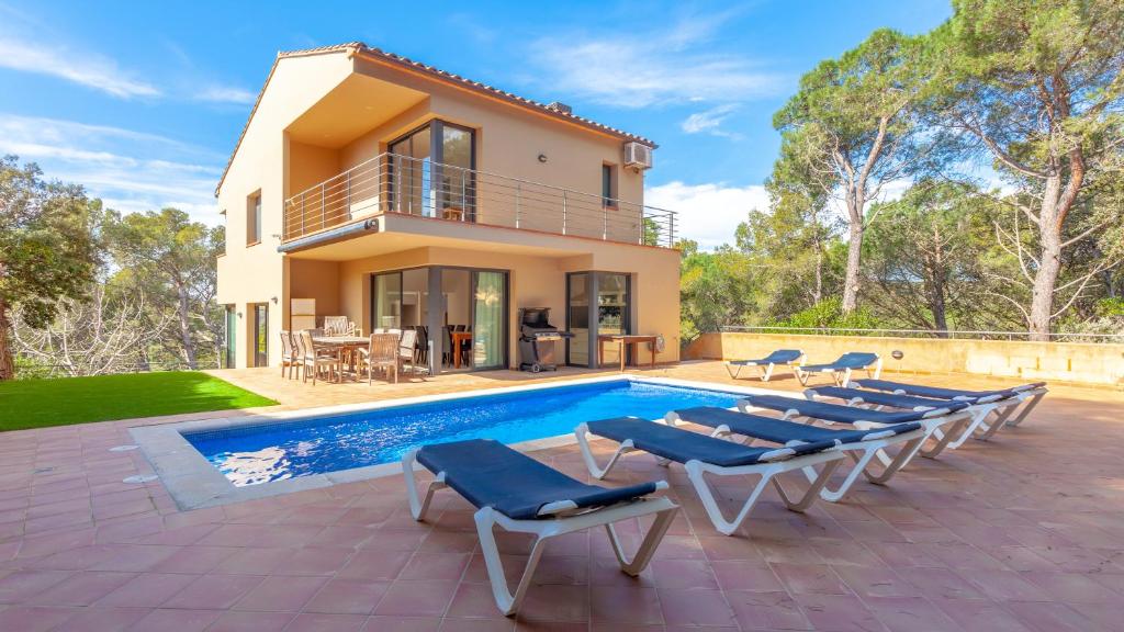 a villa with a swimming pool and a house at VISTA ALEGRE in Tamariu