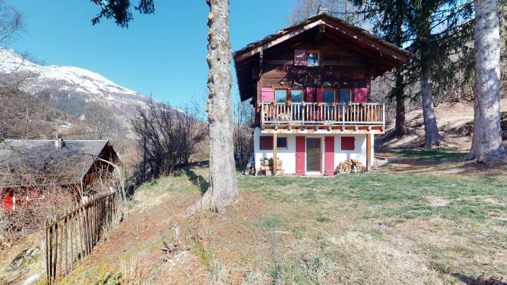 a small house with a balcony in the woods at Idyllic chalet in Evolène, with view on the Dent Blanche and the mountains in Evolène
