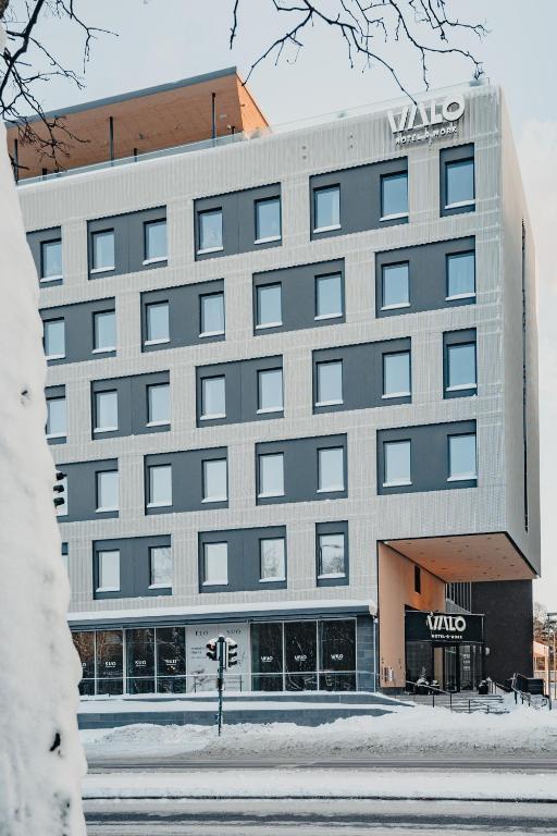 a building with a sign on the front of it at VALO Hotel & Work Helsinki in Helsinki